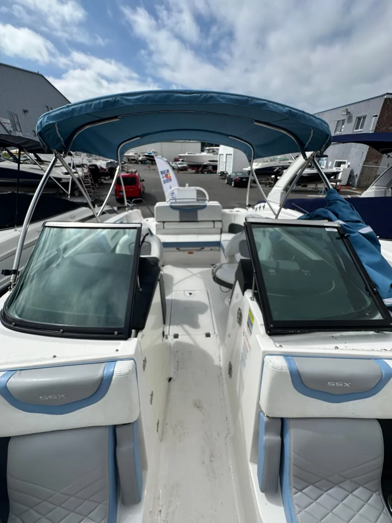 Slide: The Image of 2022 Chaparral 267 SSX OB boat with blue canopy and sleek interior design. - 28
