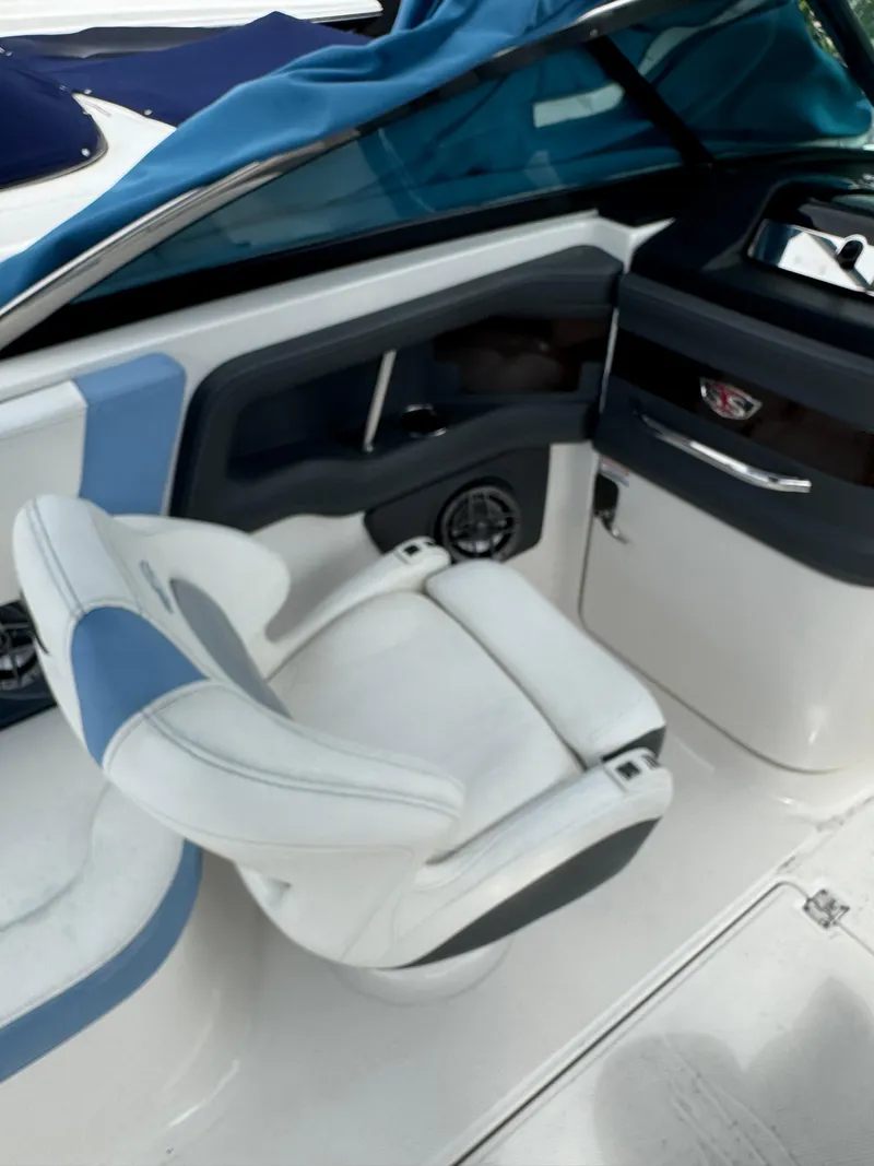 Slide: The Image of 2022 Chaparral 267 SSX OB boat interior with white and blue seating. - 29