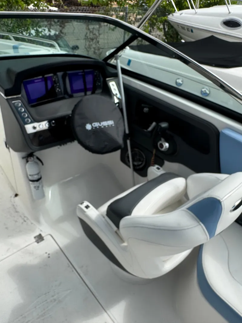 Slide: The Image of 2022 Chaparral 267 SSX OB boat cockpit with steering wheel and control panel. - 30