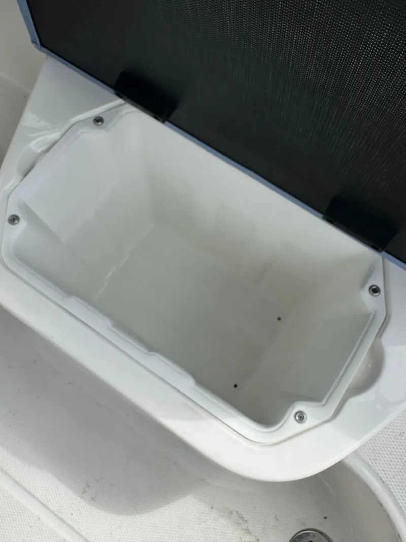 Slide: The Image of Open storage compartment on 2022 Chaparral 267 SSX OB boat. - 31