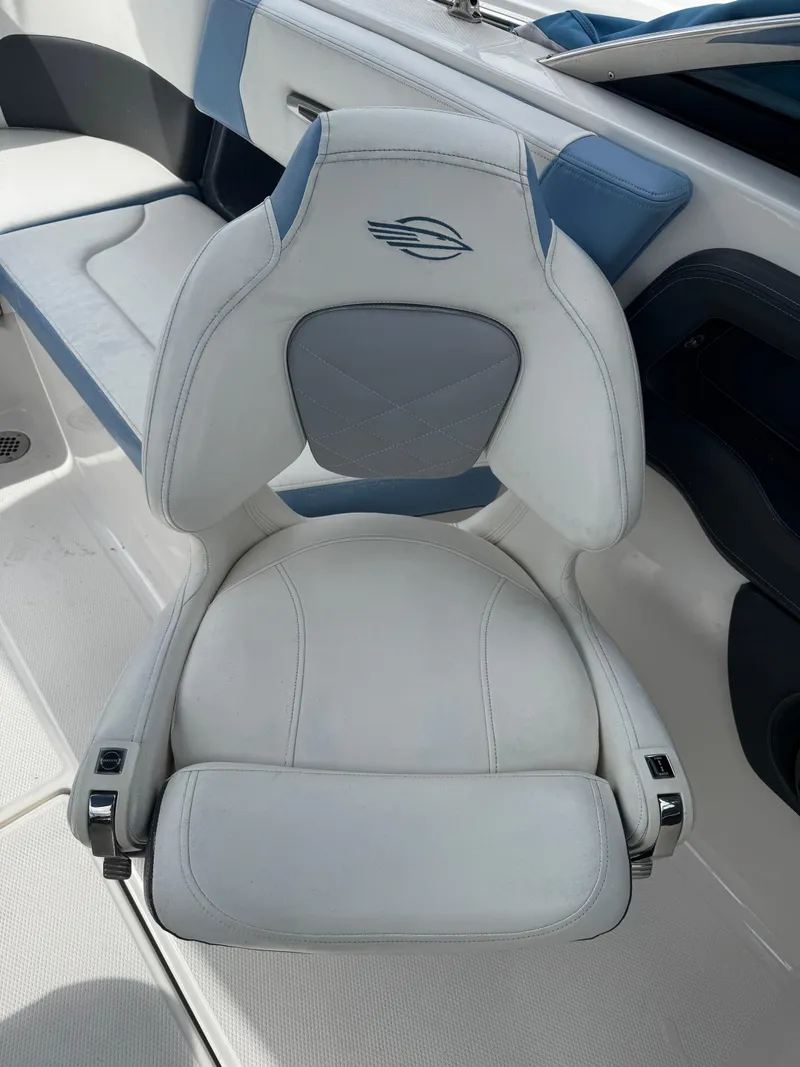 Slide: The Image of 2022 Chaparral 267 SSX OB boat seat, white and blue design, luxury marine interior. - 9