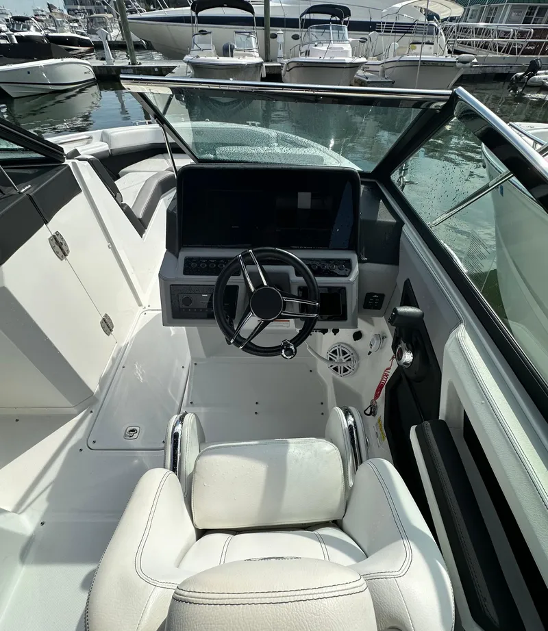 Slide: The Image of 2022 Cobalt R6 Outboard boat cockpit with steering wheel and modern dashboard. - 10