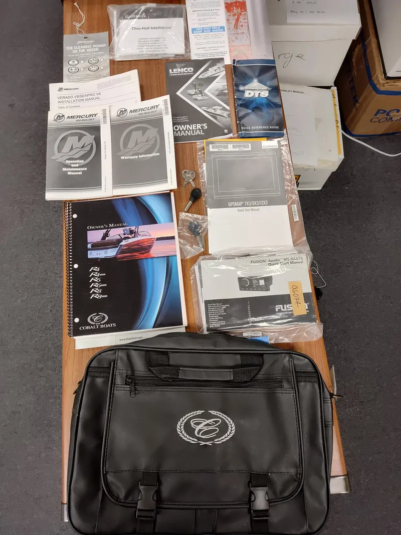 Slide: The Image of Cobalt R6 Outboard 2022 manuals and accessories displayed on a table. - 12