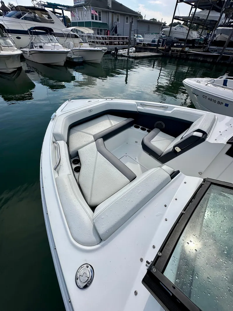 Slide: The Image of 2022 Cobalt R6 Outboard boat with sleek seating at marina. - 4