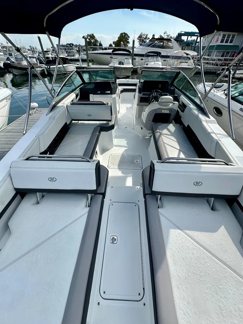 Slide: The Image of 2022 Cobalt R6 Outboard boat with spacious seating at a marina. - 5