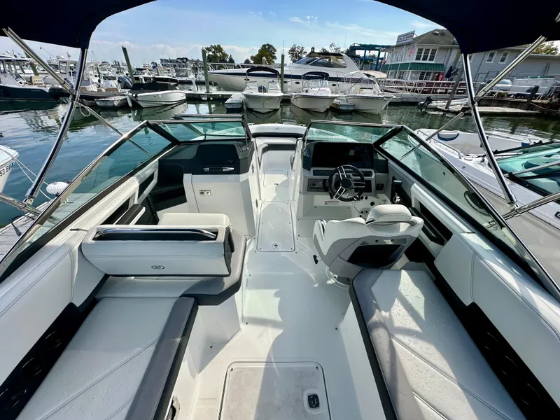 Slide: The Image of 2022 Cobalt R6 Outboard boat interior at marina, featuring sleek seating and modern controls. - 6