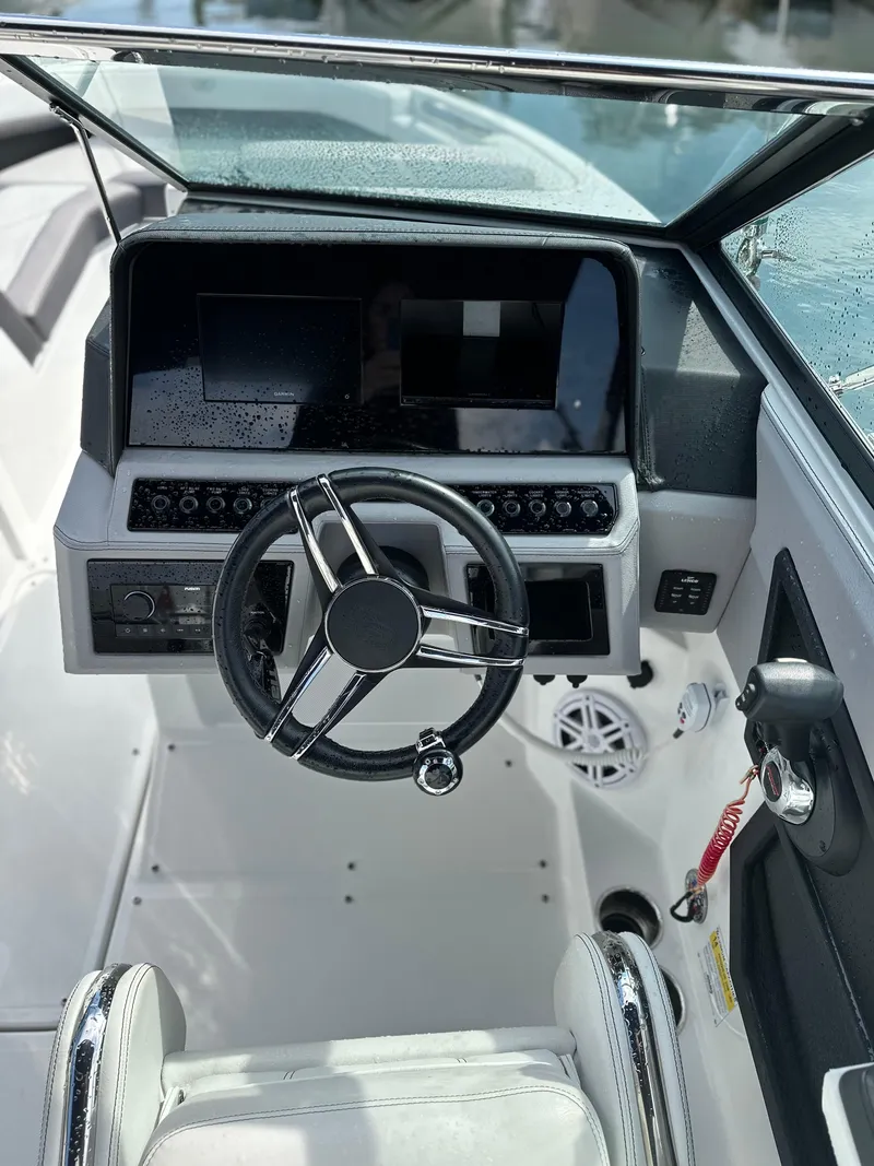 Slide: The Image of 2022 Cobalt R6 Outboard boat cockpit with modern steering and dashboard controls. - 7