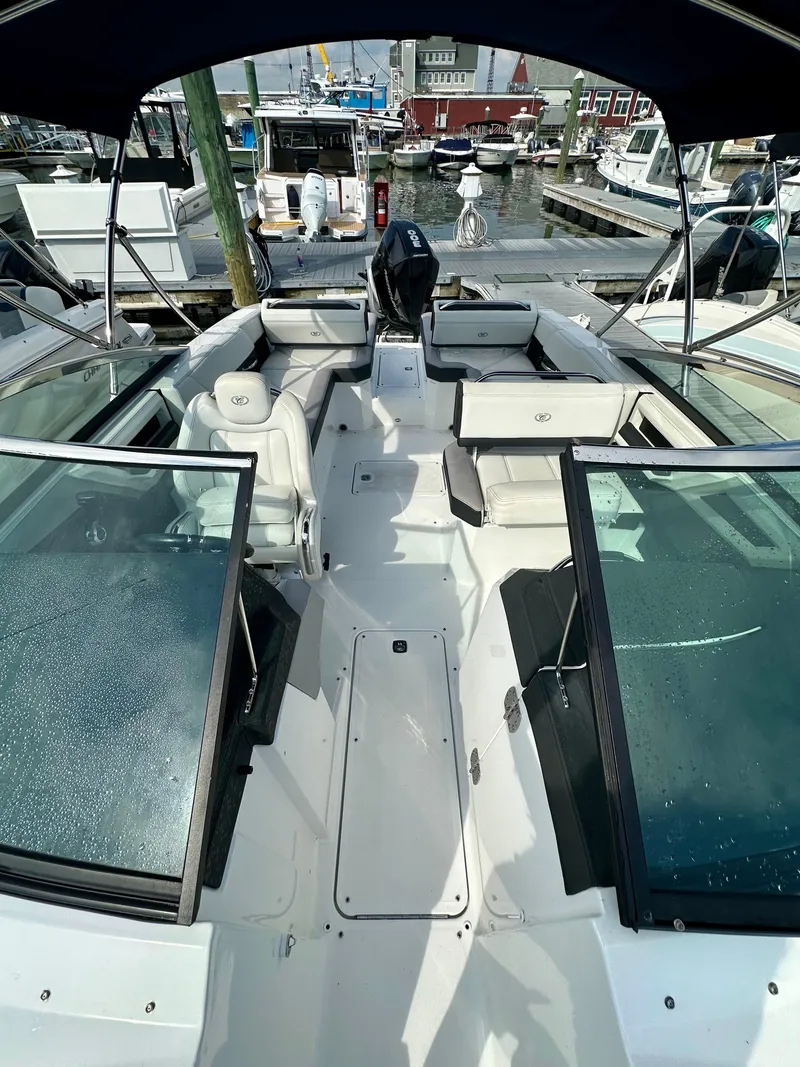 Slide: The Image of 2022 Cobalt R6 Outboard boat with spacious seating at a marina. - 9