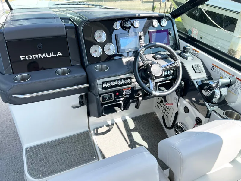 Slide: The Image of 2018 Formula 330 CRB boat dashboard with modern controls and navigation displays. - 10