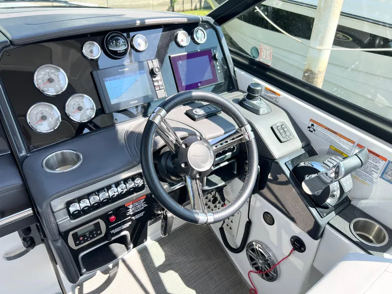 Slide: The Image of Cockpit of a 2018 Formula 330 CRB boat with modern controls and navigation displays. - 11