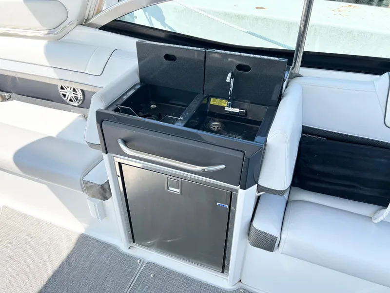 Slide: The Image of 2018 Formula 330 CRB boat interior with compact kitchenette and seating area. - 12