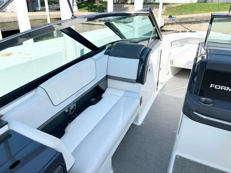 Slide: The Image of 2018 Formula 330 CRB boat interior with white seating and sleek design. - 14