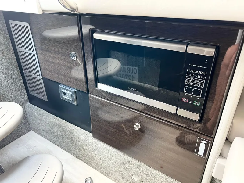 Slide: The Image of 2018 Formula 330 CRB interior with modern microwave and sleek cabinetry. - 18