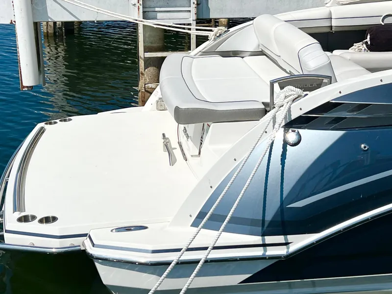 Slide: The Image of 2018 Formula 330 CRB boat docked, featuring sleek design and comfortable seating. - 2