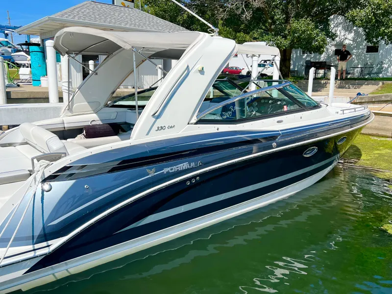 Slide: The Image of 2018 Formula 330 CRB boat docked in a marina, featuring sleek design and modern amenities. - 3