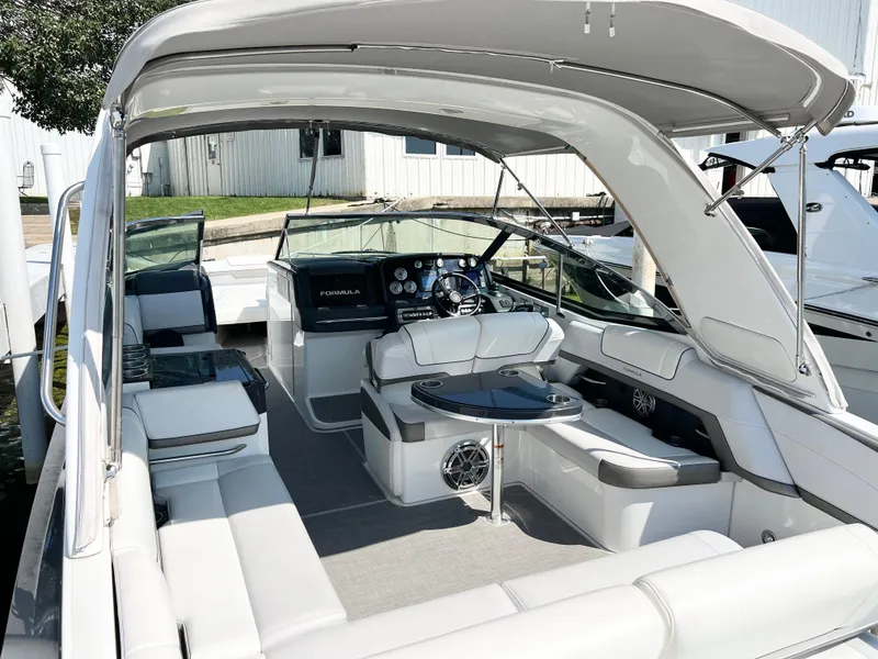 Slide: The Image of 2018 Formula 330 CRB boat interior with luxurious seating and modern dashboard. - 5