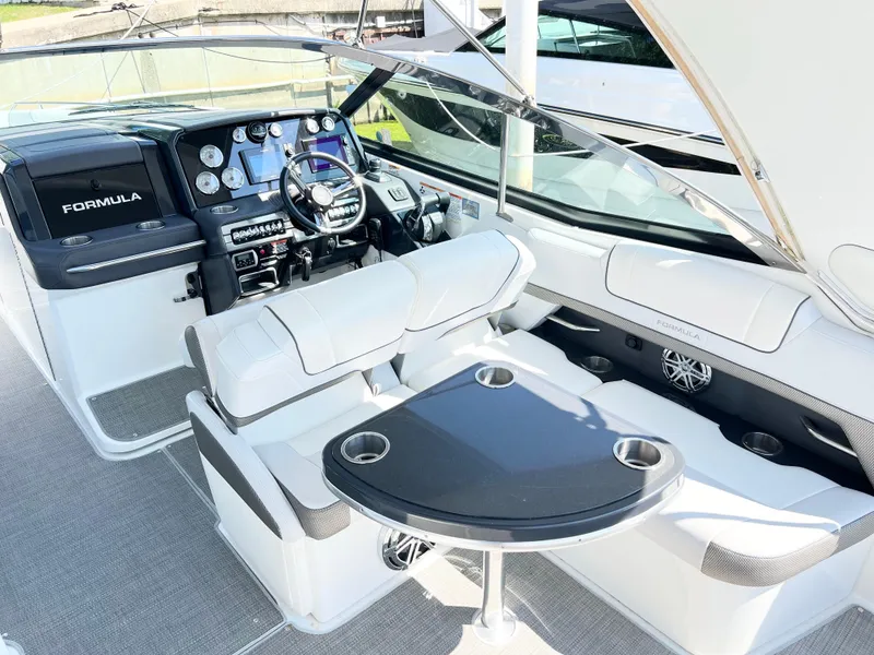 Slide: The Image of 2018 Formula 330 CRB boat interior with sleek dashboard and comfortable seating. - 7