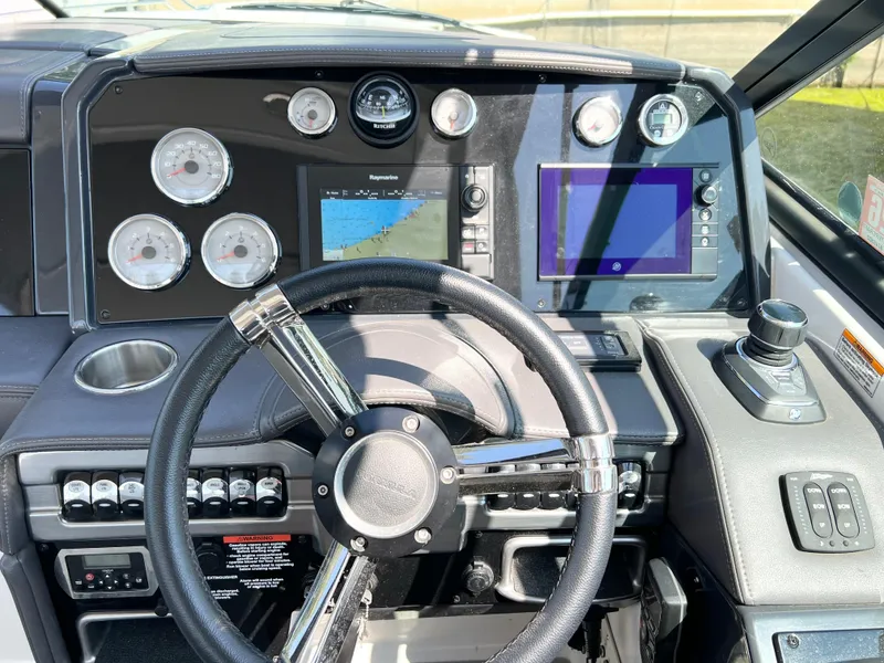 Slide: The Image of Cockpit of 2018 Formula 330 CRB boat with steering wheel and navigation displays. - 9