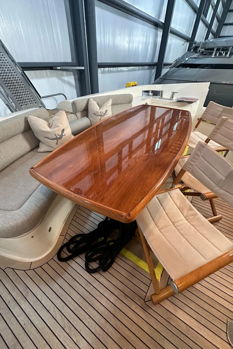 Slide: The Image of Luxurious Azimut 62E yacht interior with elegant wooden table and comfortable seating, 2011 model. - 14