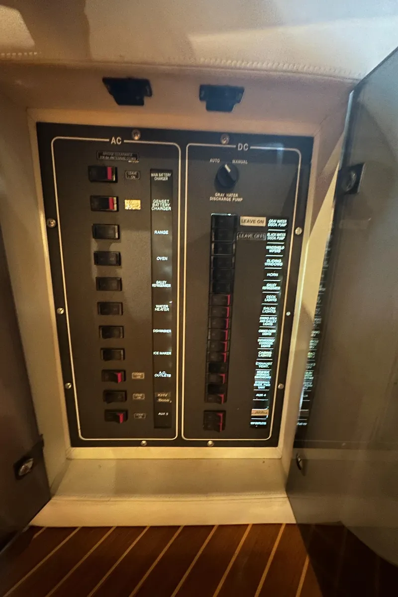 Slide: The Image of Electrical panel on a 2011 Azimut 62E yacht, featuring AC and DC switches. - 23