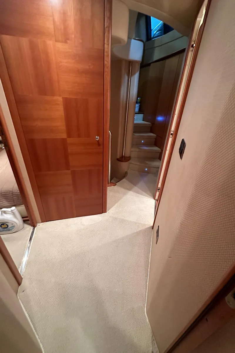Slide: The Image of Interior hallway of 2011 Azimut 62E yacht with wooden door and carpeted floor. - 24