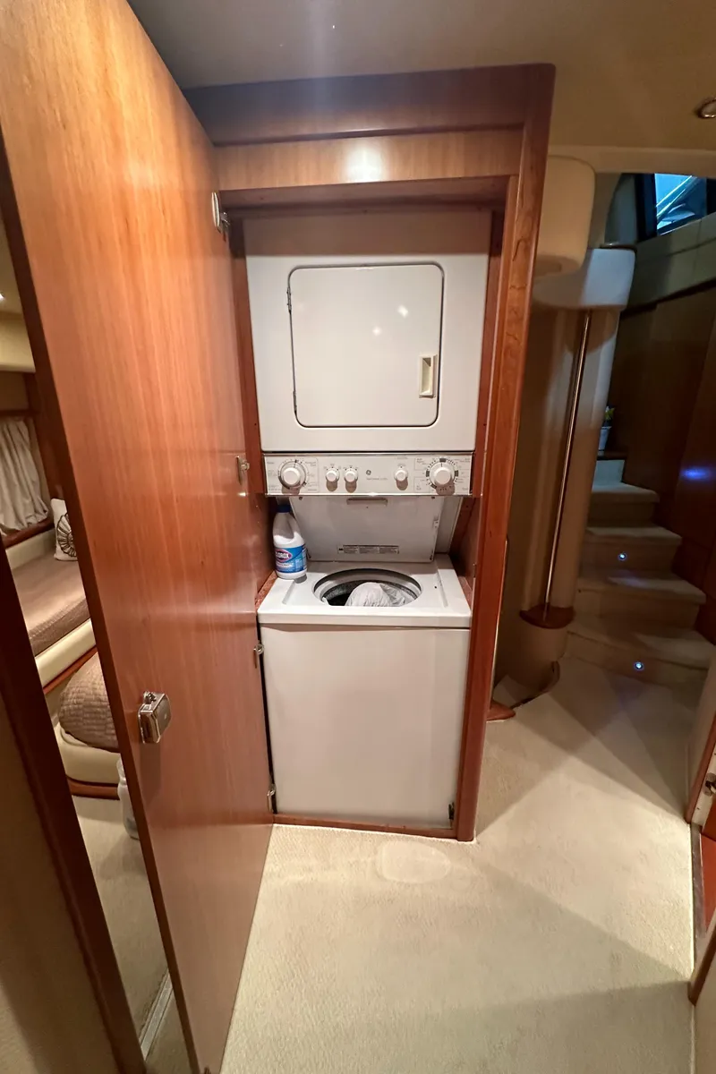 Slide: The Image of 2011 Azimut 62E yacht interior with a compact laundry area. - 25