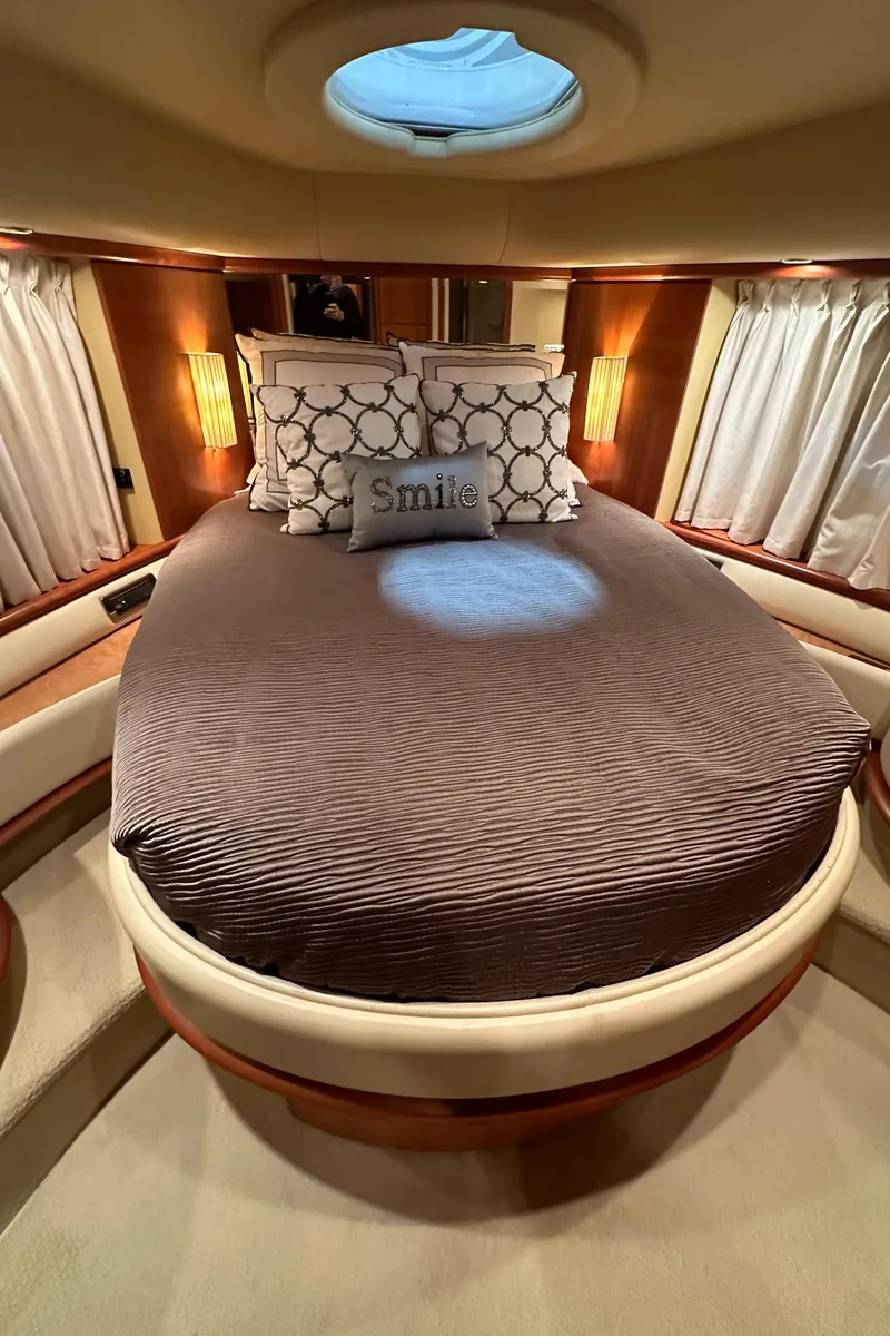 Slide: The Image of Luxurious bedroom interior of a 2011 Azimut 62E yacht with elegant bedding and ambient lighting. - 30