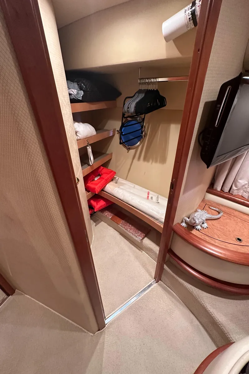 Slide: The Image of 2011 Azimut 62E yacht interior storage closet with shelves and hanging space. - 33