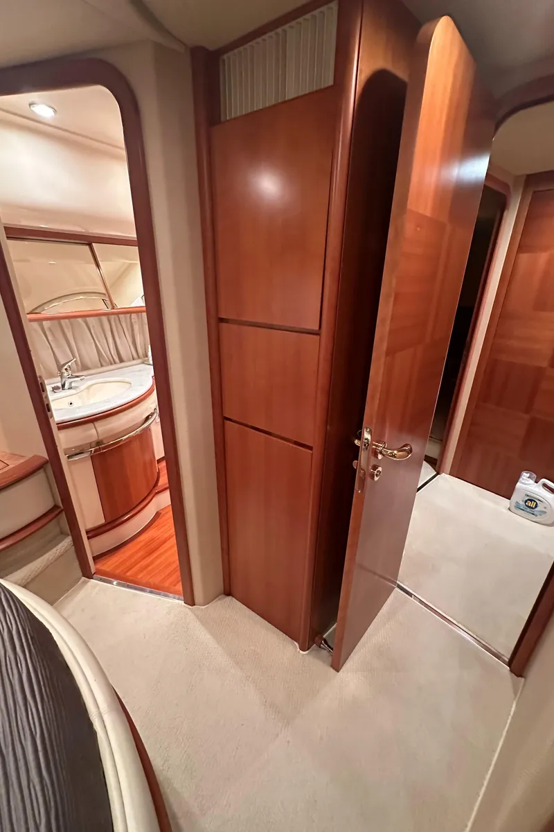 Slide: The Image of Interior of 2011 Azimut 62E yacht, featuring wood paneling and luxurious cabin design. - 34