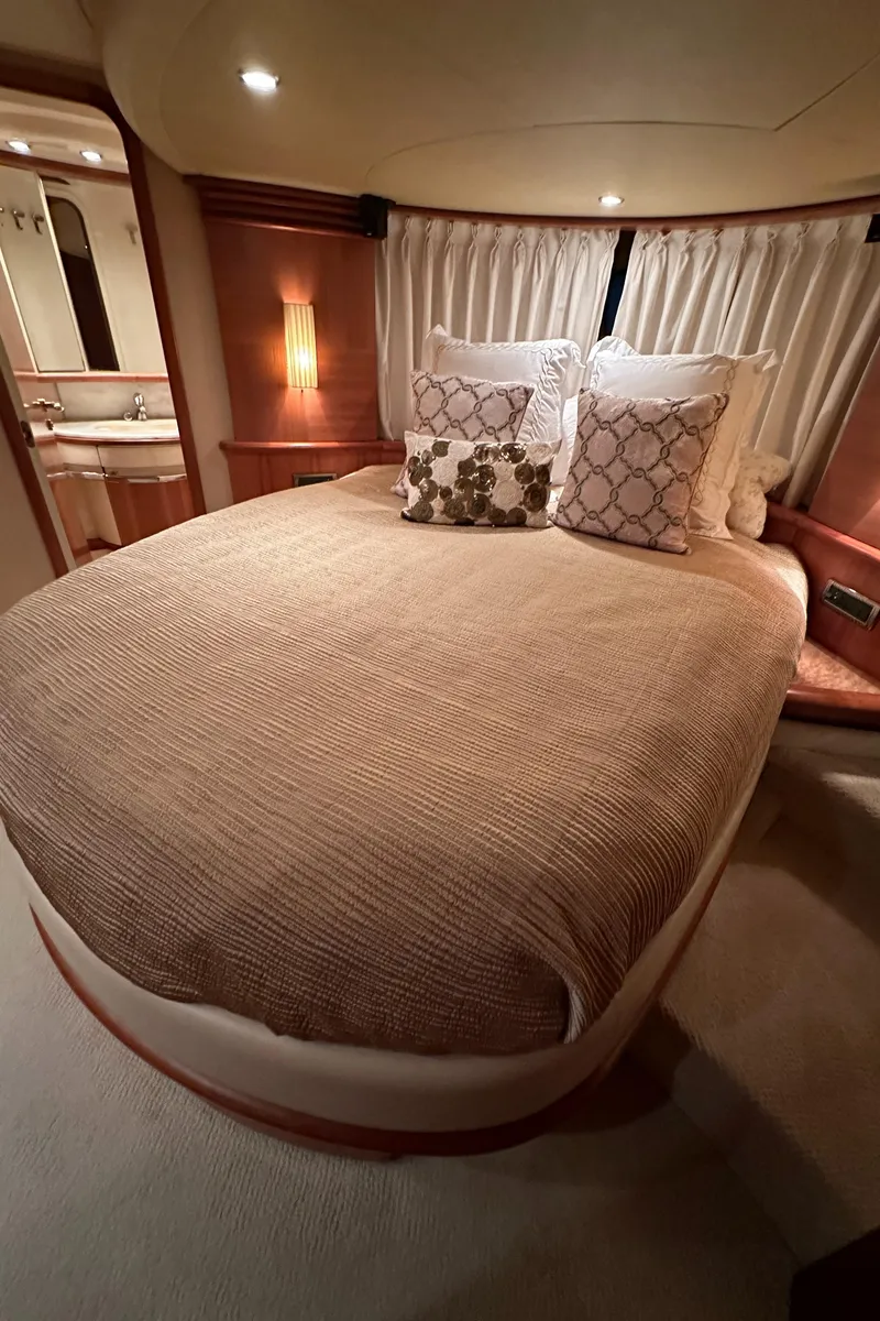 Slide: The Image of Luxurious bedroom interior of 2011 Azimut 62E yacht with elegant bedding and ambient lighting. - 37