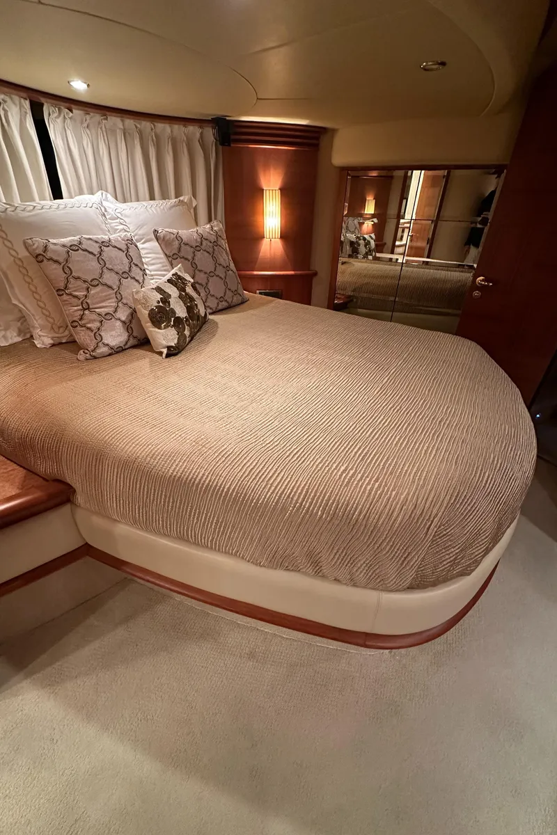 Slide: The Image of Luxurious bedroom interior of 2011 Azimut 62E yacht with elegant bedding and warm lighting. - 38