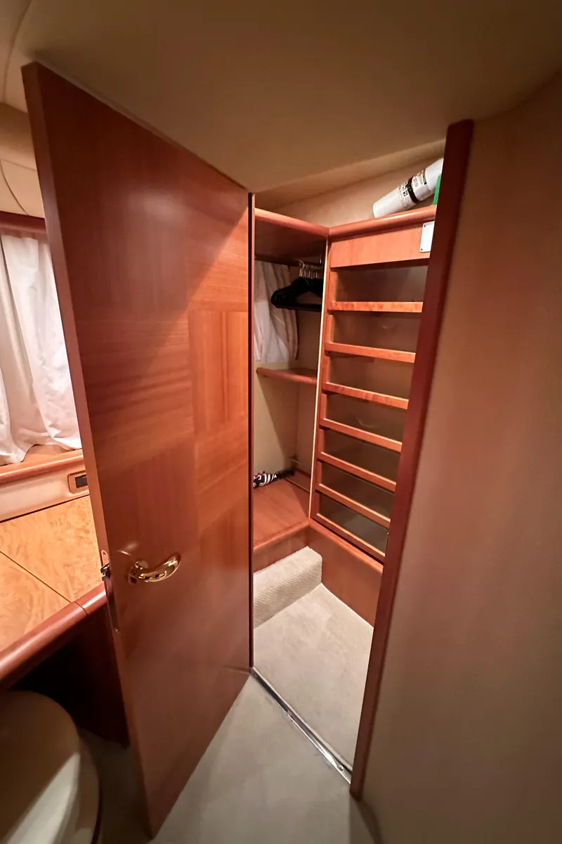 Slide: The Image of Interior of 2011 Azimut 62E yacht, featuring a wooden closet and shelving. - 43