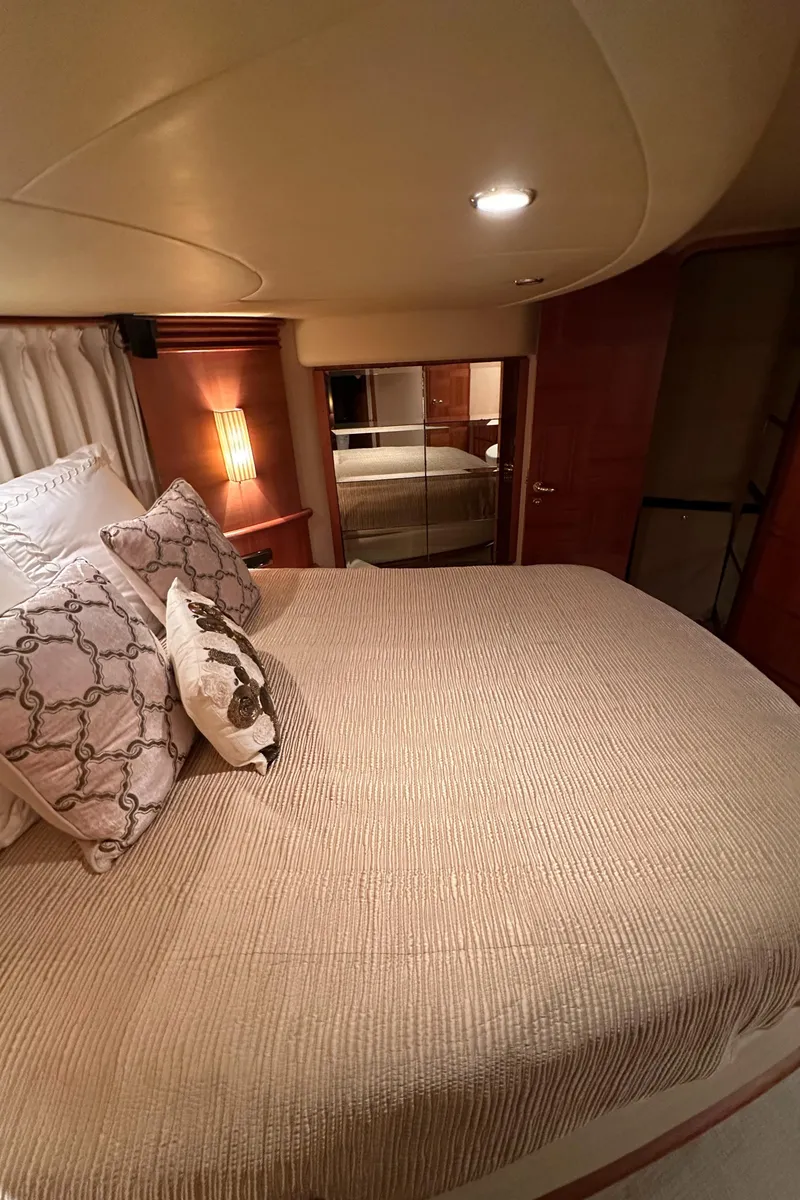 Slide: The Image of Luxurious bedroom interior of 2011 Azimut 62E yacht with elegant bedding and ambient lighting. - 47