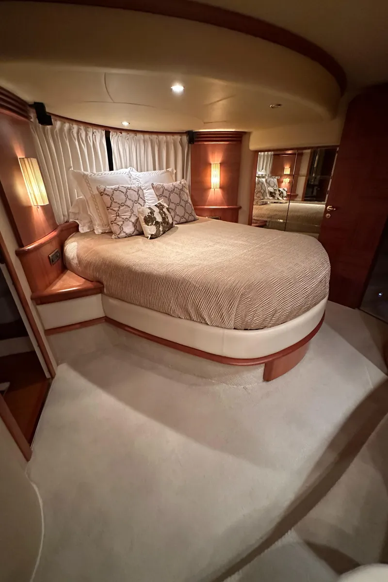Slide: The Image of Luxurious bedroom interior of 2011 Azimut 62E yacht with elegant bedding and ambient lighting. - 49