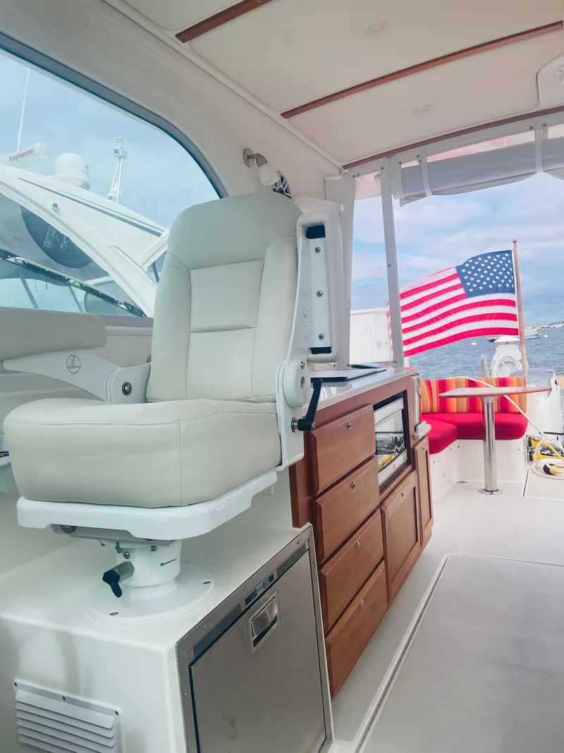 Slide: The Image of Lebroc Helm seat with cherry paneled galley looking astern - 23