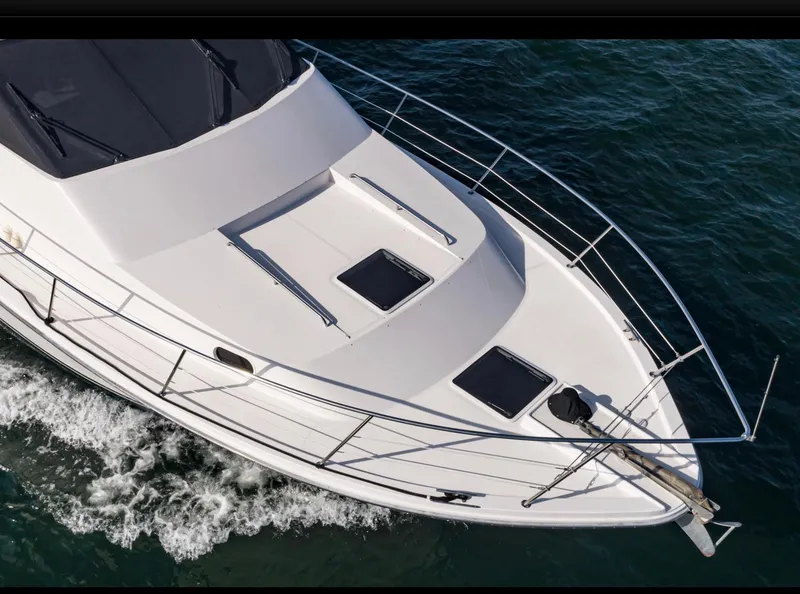 Slide: The Image of 1998 Pacific Mariner 65 Motoryacht cruising on open water, aerial view. - 13