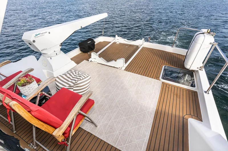 Slide: The Image of 1998 Pacific Mariner 65 Motoryacht deck with seating, crane, and ocean view. - 15