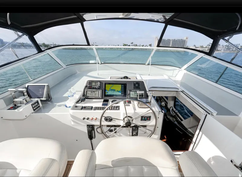 Slide: The Image of 1998 Pacific Mariner 65 Motoryacht helm with navigation equipment and ocean view. - 19
