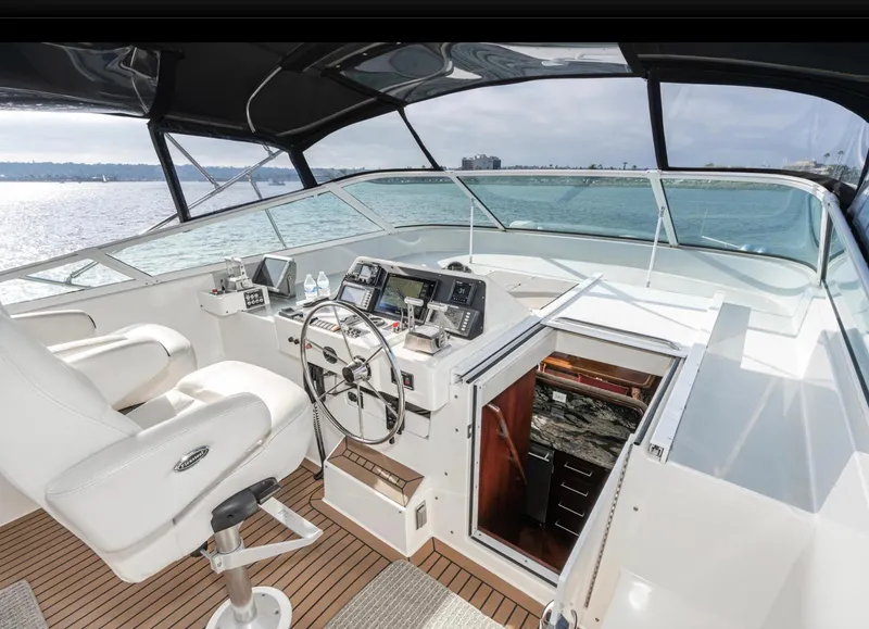 Slide: The Image of 1998 Pacific Mariner 65 Motoryacht helm with ocean view, featuring modern navigation equipment. - 20