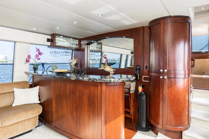 Slide: The Image of Luxurious interior of 1998 Pacific Mariner 65 Motoryacht with elegant wood finishes and bar area. - 28