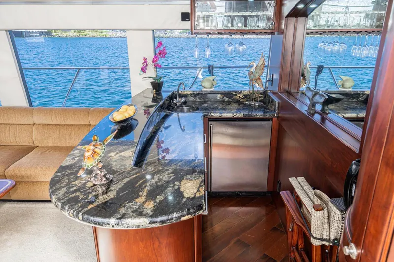Slide: The Image of Luxurious interior of 1998 Pacific Mariner 65 Motoryacht with elegant bar and waterfront view. - 29