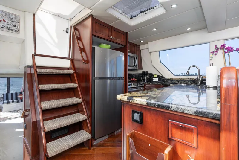 Slide: The Image of Luxurious kitchen interior of 1998 Pacific Mariner 65 Motoryacht with wood cabinetry and modern appliances. - 30