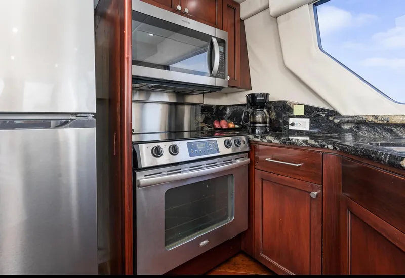 Slide: The Image of Luxurious kitchen in 1998 Pacific Mariner 65 Motoryacht with modern appliances and wood cabinetry. - 33