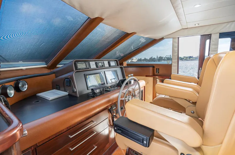 Slide: The Image of 1998 Pacific Mariner 65 Motoryacht helm with leather seats and navigation instruments. - 41