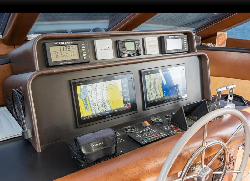 Slide: The Image of Control panel of a 1998 Pacific Mariner 65 Motoryacht with navigation screens and instruments. - 42