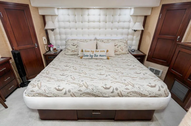 Slide: The Image of Luxurious bedroom in 1998 Pacific Mariner 65 Motoryacht with elegant bedding and wood accents. - 48