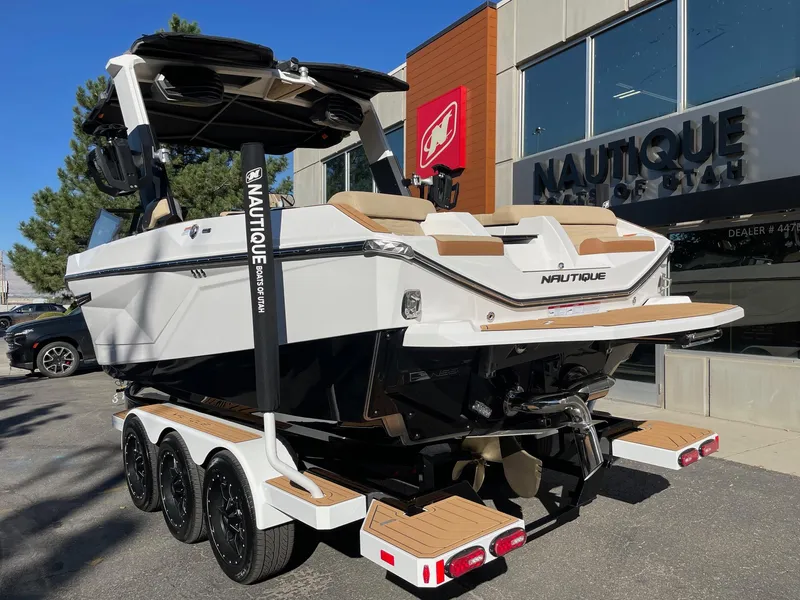 Slide: The Image of 2025 Nautique Super Air Nautique G23 boat on trailer outside dealership. - 3