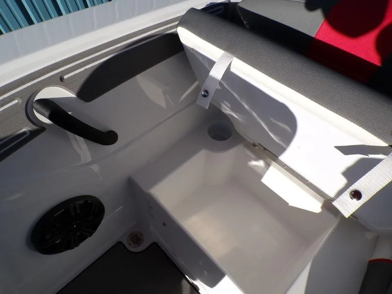 Slide: The Image of 2025 Tahoe T21 boat interior with storage compartment and speaker. - 12