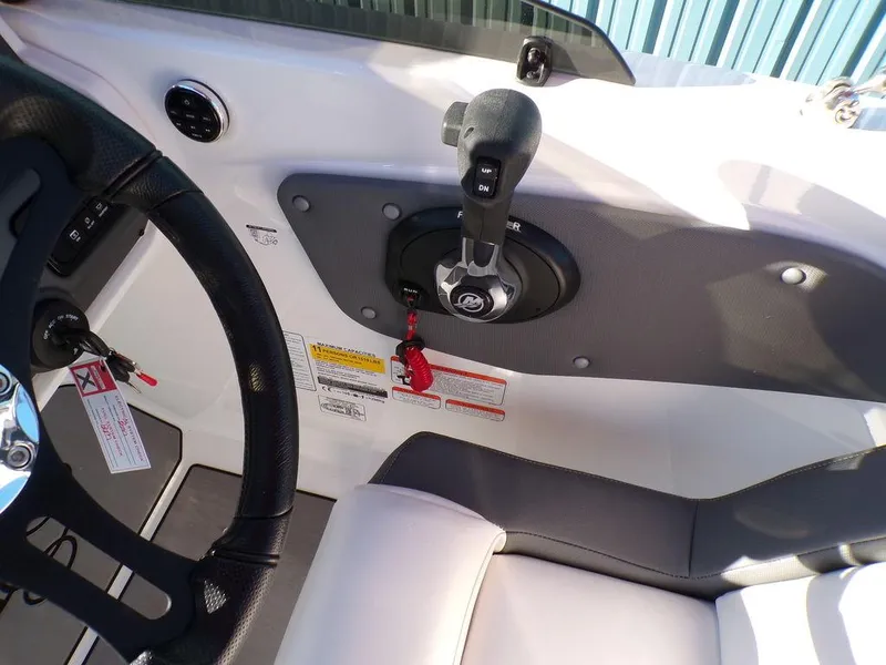 Slide: The Image of 2025 Tahoe T21 boat interior with steering wheel and control panel. - 14