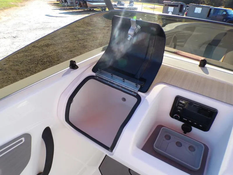 Slide: The Image of 2025 Tahoe T21 boat interior with open storage compartment and control panel. - 17